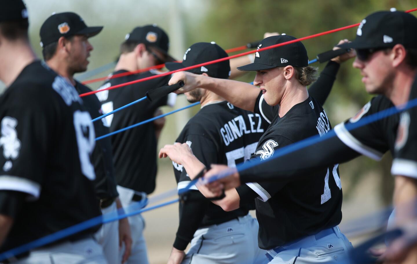 White Sox pitcher Michael Kopech, second from right, warms up during a spring training practice at Camelback Ranch on Feb. 17, 2017.