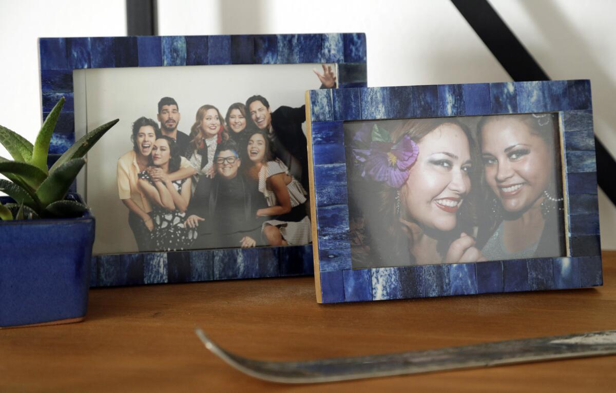 Pictures of the "Vida" cast and one with her sister Tatiana, far right, decorate Tanya Saracho's office.