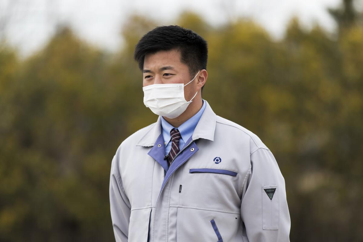A town official wears a mask