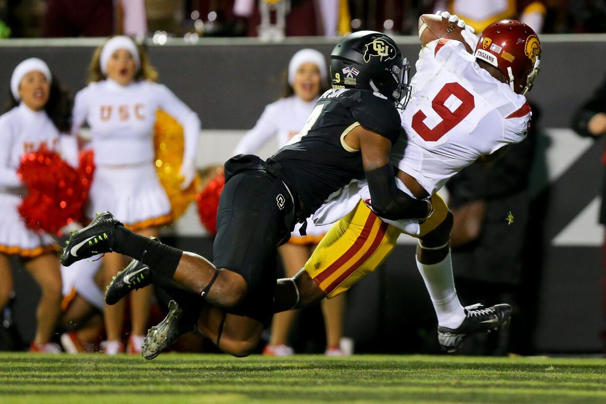 USC wide receiver JuJu Smith-Schuster catches a touchdown against Colorado defensive back Tedric Thompson in the fourth quarter Friday night in Boulder.