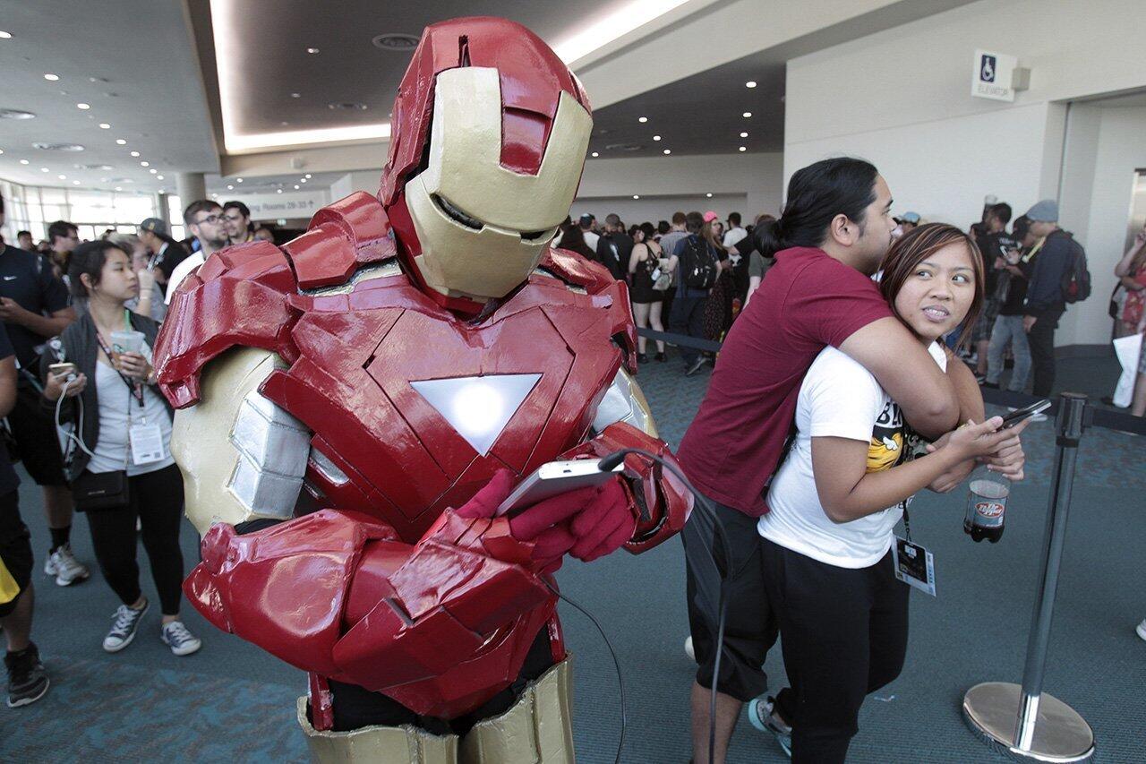 Nicholas Rodriguez, 17, wearing an Iron Man costume, continues to play Pokemon Go after security guards dispersed him and a large crowd of Pokemon Go players, who gathered on a rumor of being able to capture a rare Pokemon being released from the Pokemon