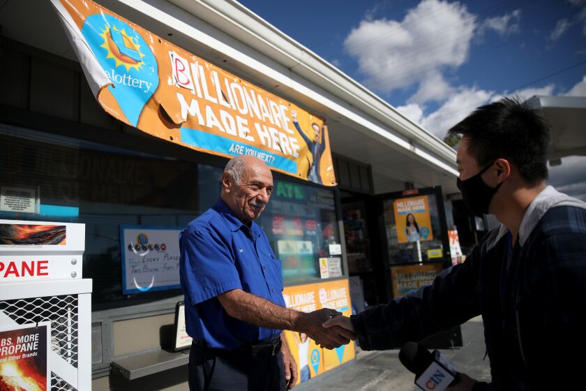 ALTADENA, CA - NOVEMBER 09: Joseph Chahayed, 74, left, owner of Joe's Service Station, now an ExxonMobil franchise, sold the winning Powerball ticket worth more than $2 billion, gives an interview to a news organization on Wednesday, Nov. 9, 2022 in Altadena, CA. Chahayed will be receiving a $1-million bonus check for selling the $2.04-billion jackpot-winning ticket. (Gary Coronado / Los Angeles Times)