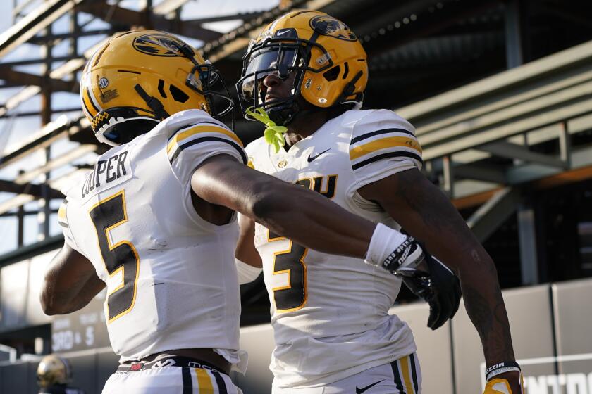 Missouri wide receivers Mookie Cooper (5) and Luther Burden III (3) celebrate after a touchdown against Vanderbilt in the second half of an NCAA college football game Saturday, Sept. 30, 2023, in Nashville, Tenn. (AP Photo/George Walker IV)