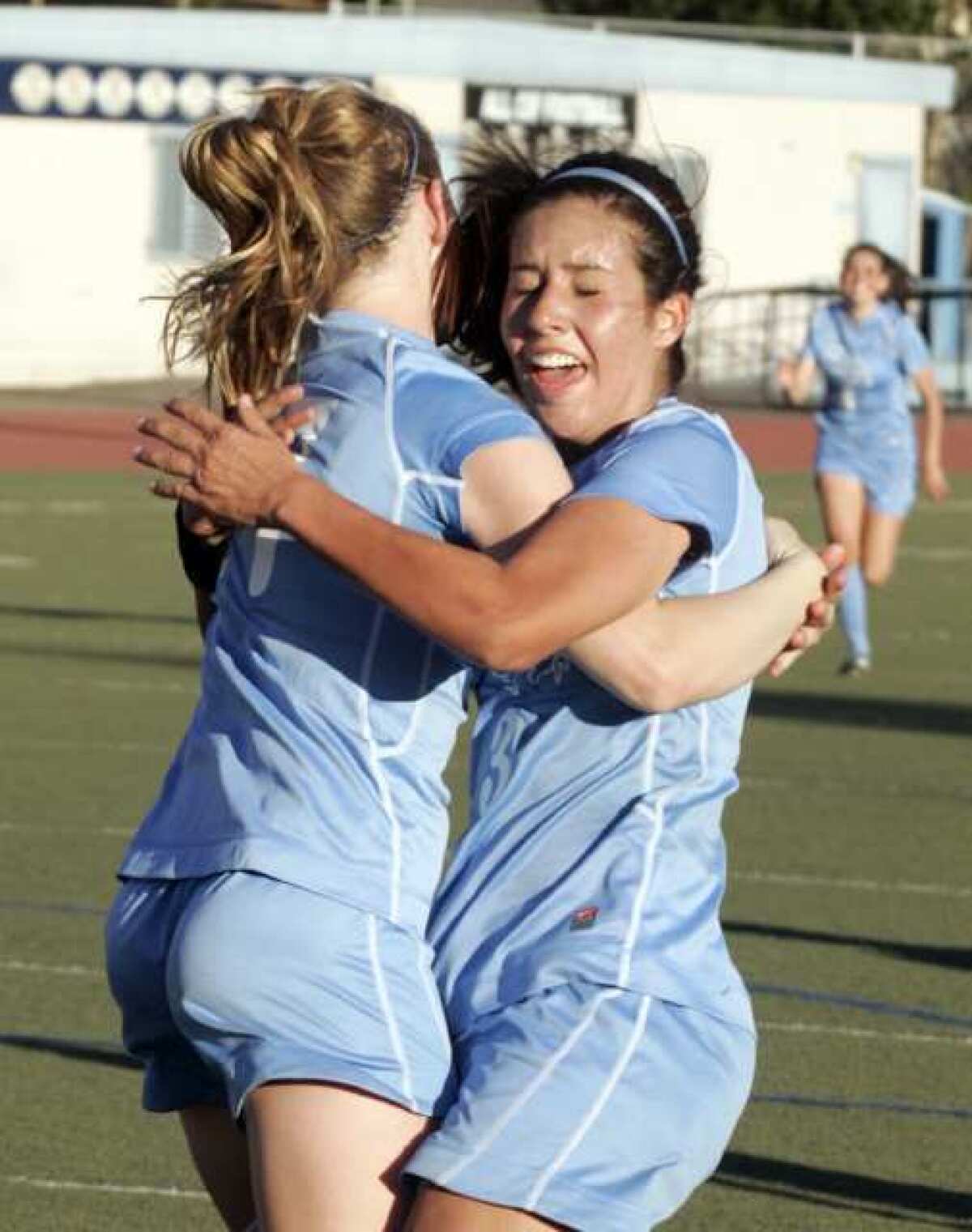 Crescenta Valley's Jacque Phinney, right, hugs to congratulate Sierra Rhoads who just scored a goal late in the second half against Arcadia in a Pacific League girls soccer match at Crescenta Valley High School in La Crescenta on Thursday, February 9, 2012. For four seasons, the Crescenta Valley High girls' soccer trio of Sierra Rhoads, Whitley Boller and Katie Callister plied their trade in helping and eventually leading the Falcons to Pacific League success and a pair of playoff wins.