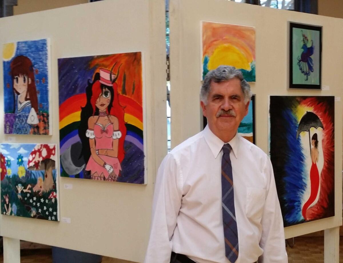 Curator Jay Belloli, in front of artwork.