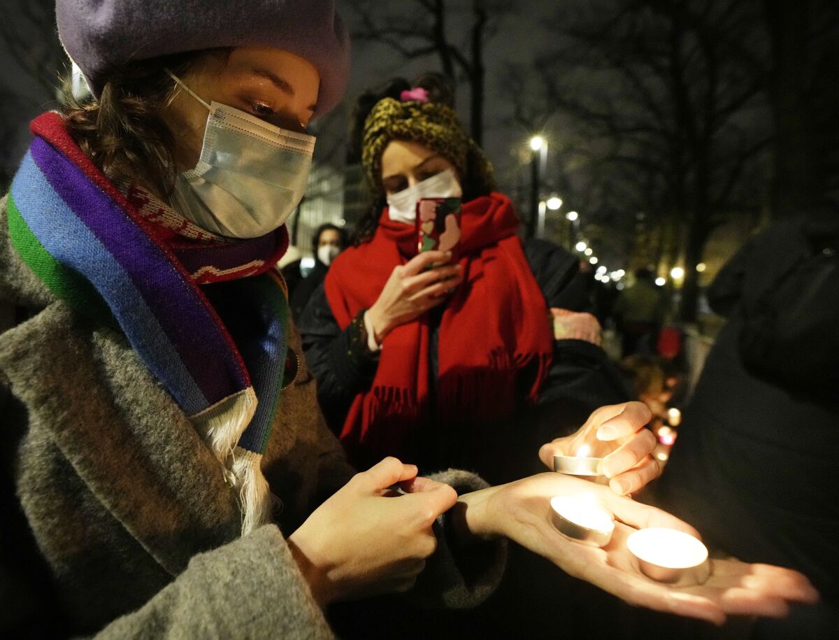 FILE - A group of women's rights activists protest against Poland's strict anti-abortion law, outside the top constitutional court, in Warsaw, Poland, Jan. 26, 2022. The government of Poland, where a near-total abortion ban is in place, faced accusations Monday, June 6, 2022, of creating a “pregnancy register” as the country expands the amount of medical data being digitally saved on patients. (AP Photo/Czarek Sokolowski, File)