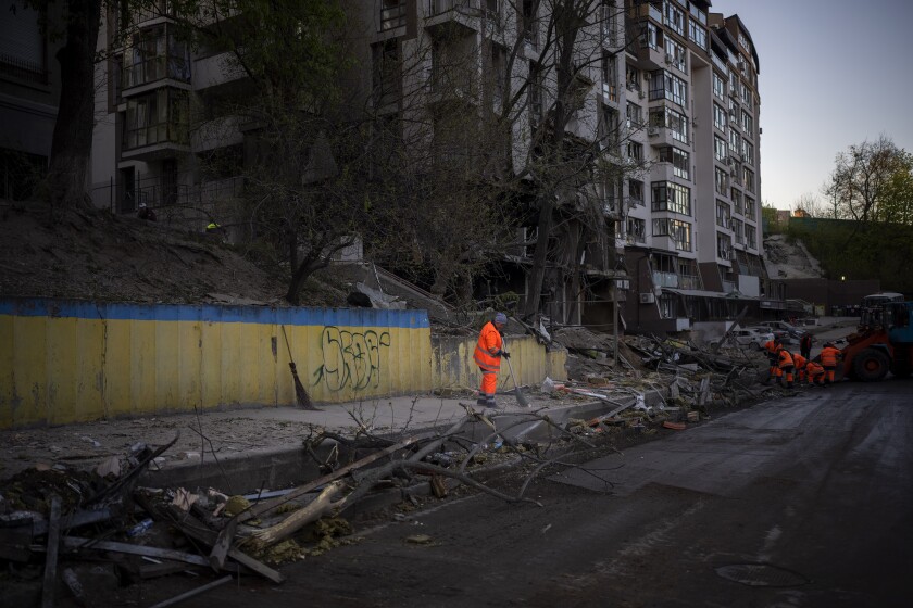 Cleanup crews at the explosion site in Kyiv, Ukraine