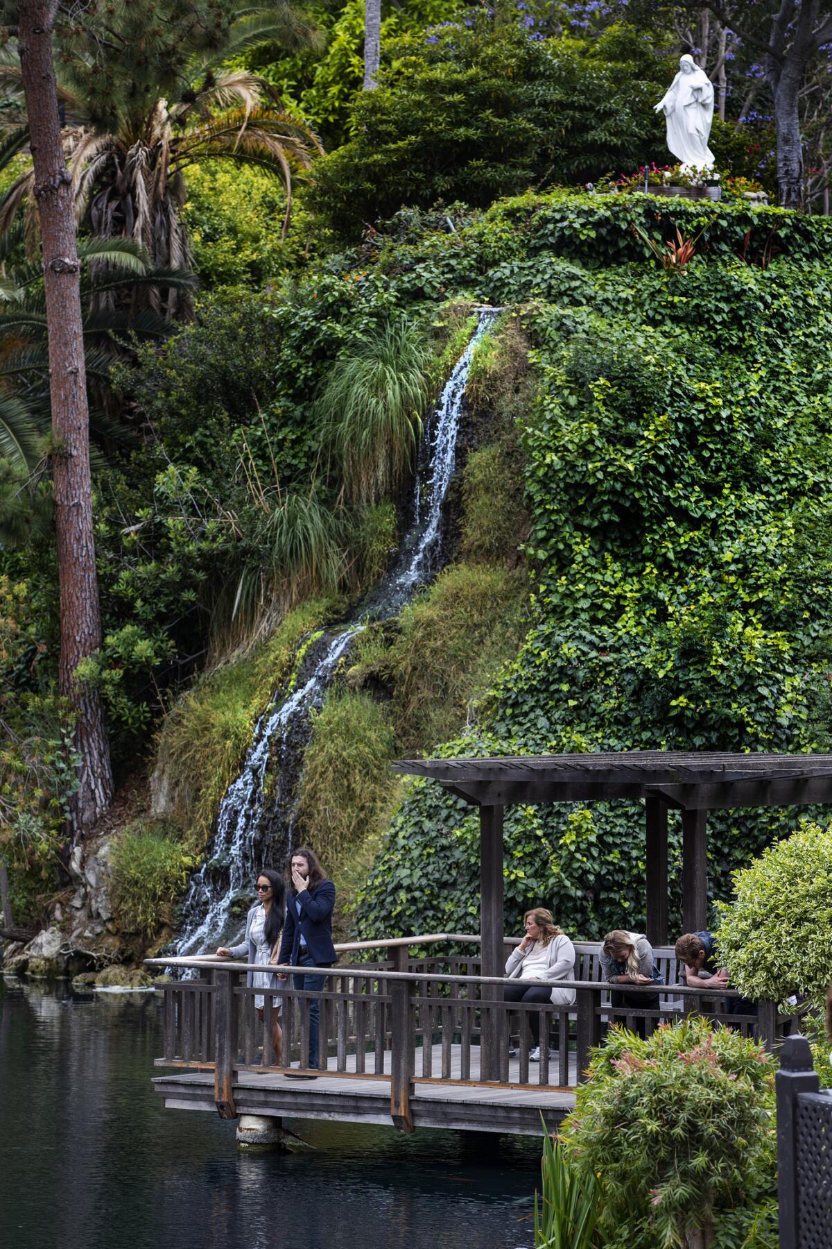 Members of the public enjoy the solace of the lake in the Meditation Gardens at the Lake Shrine Self Realization Fellowship silence retreat.