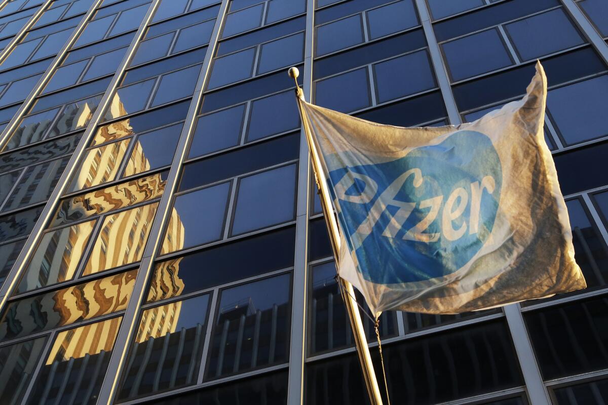 A Pfizer flag is displayed in front of world headquarters on Monday in New York.
