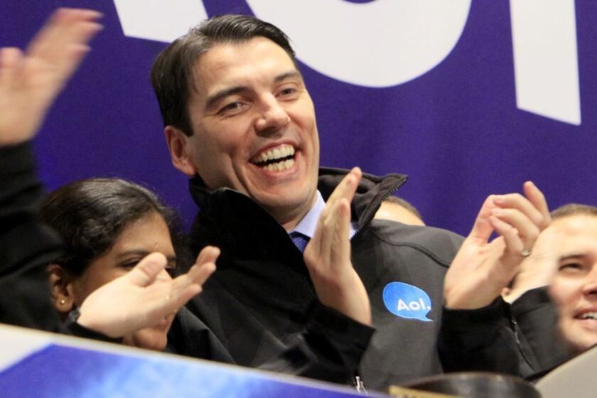 FILE - In this Dec. 10, 2009 file photo, AOL Chairman and CEO Tim Armstrong, center, applauds during opening bell ceremonies of the New York Stock Exchange. Verizon on Tuesday, May 12, 2015 announced it is buying AOL for about $4.4 billion, advancing the telecom's push in both mobile and advertising fields. (AP Photo/Richard Drew, File)