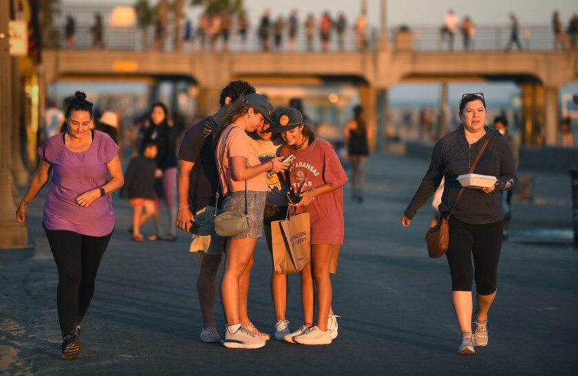 Pedestrians near the Huntington Beach Pier.
