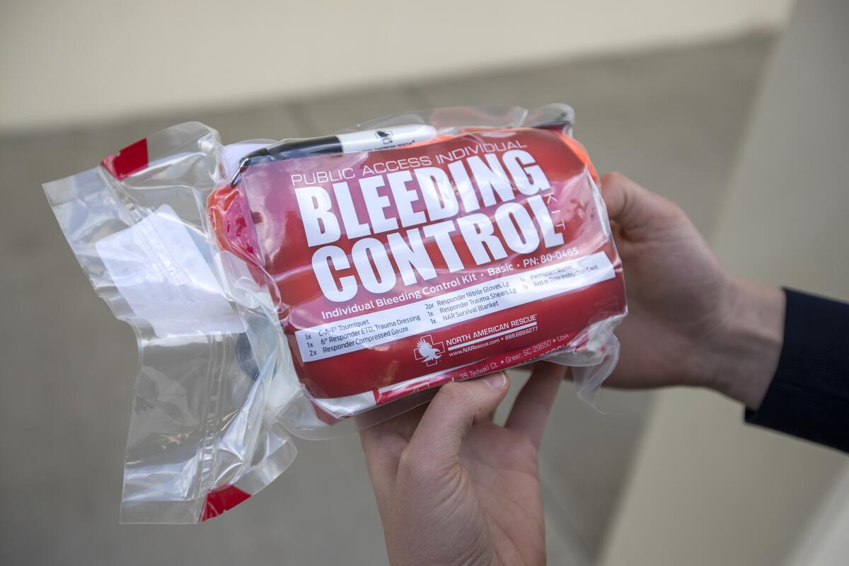 Sophia Cendro holds a bleeding-control kit, one of 140 that will be distributed on the Huntington Beach High School campus after Monday's Trauma for Teachers training involving school faculty and other staff.