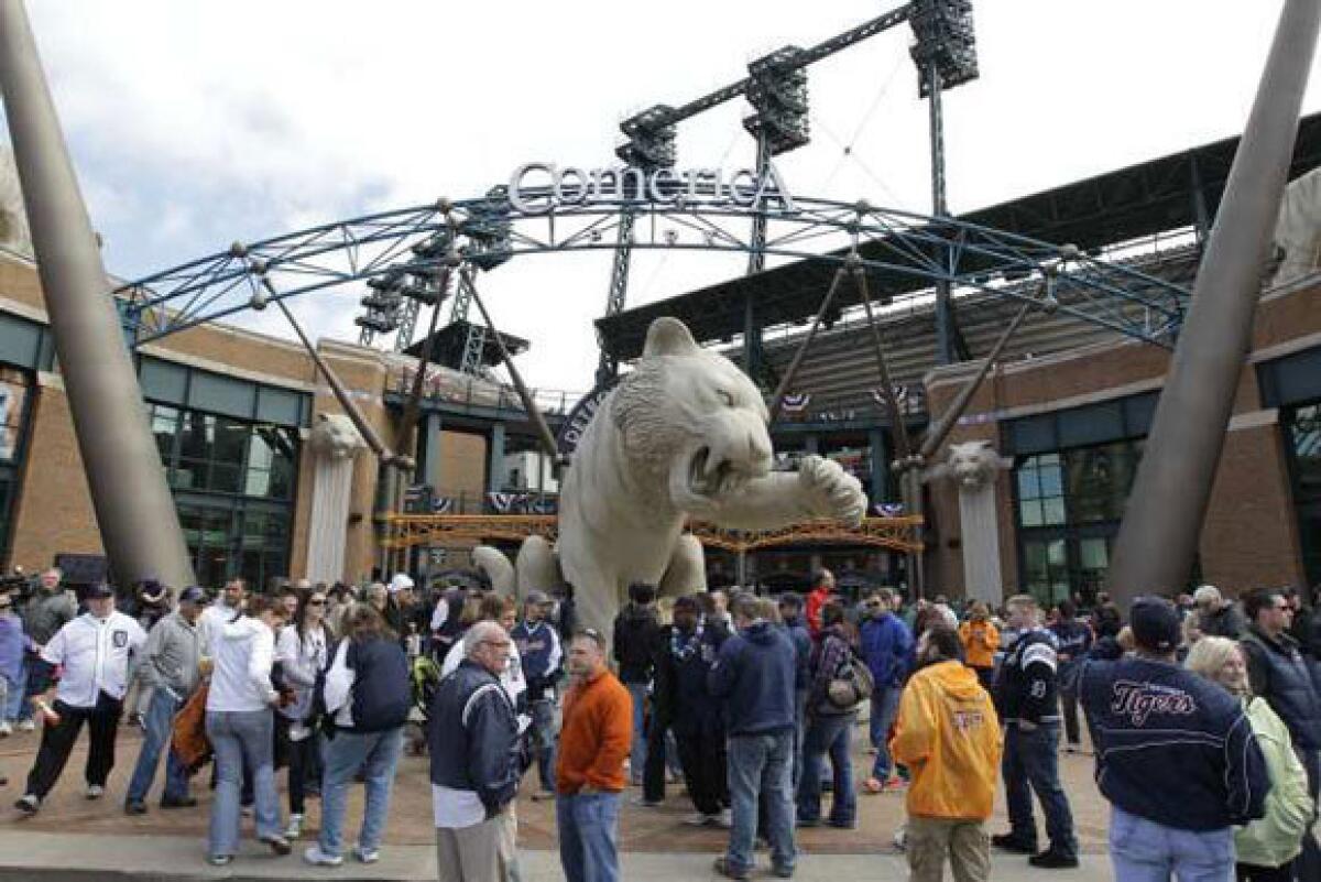 Fans mill about outside Comerica Park before a game in April.
