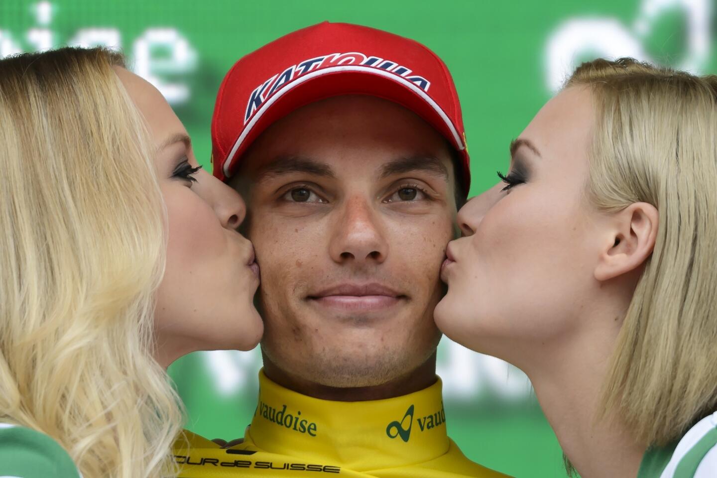 Hostesses kiss race winner, Slovenian rider Simon Spilak of Katusha team, during the podium ceremony following the final stage of the Tour of Switzerland (Tour de Suisse) UCI World Tour, a 38,4 km individual time-trial race in the streets of Swiss capital Bern, on June 21, 2015. AFP PHOTO / FABRICE COFFRINIFABRICE COFFRINI/AFP/Getty Images ** OUTS - ELSENT, FPG - OUTS * NM, PH, VA if sourced by CT, LA or MoD **