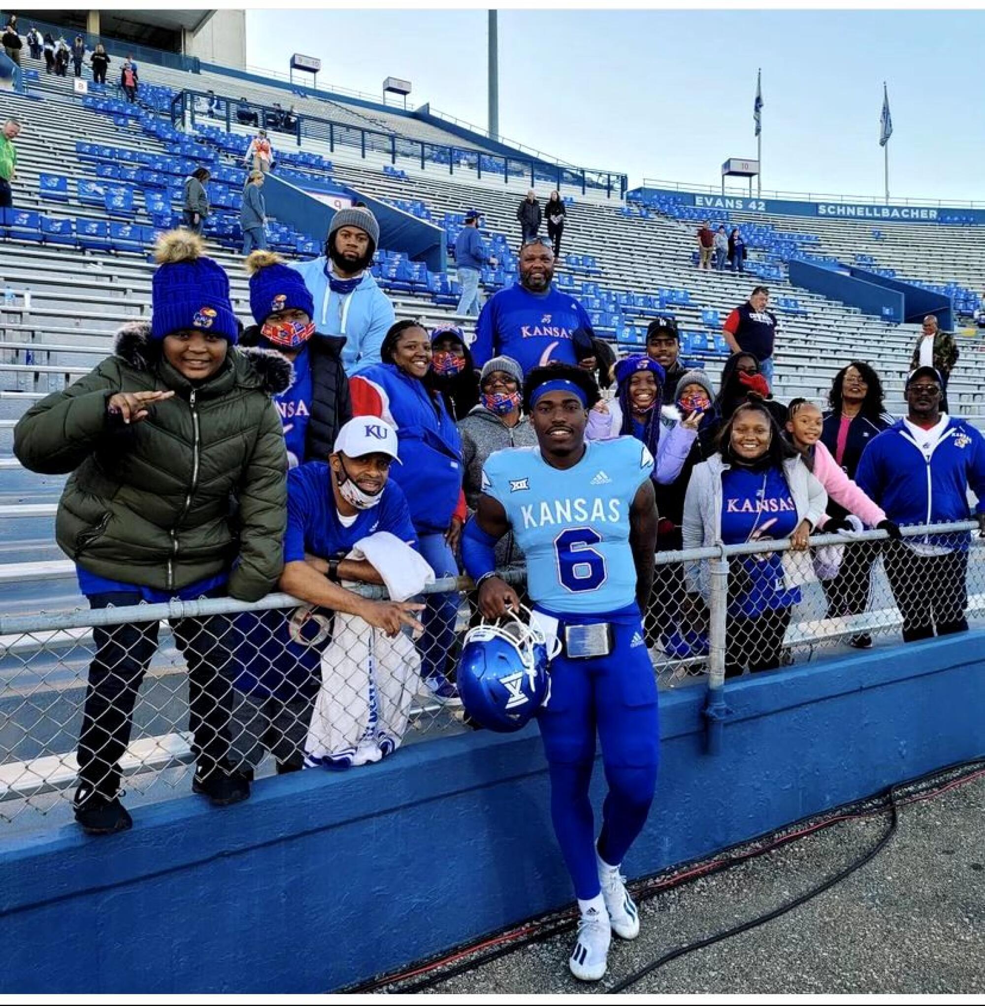 Jalon Daniels (6) is surrounded by friends and family after a Kansas football game.