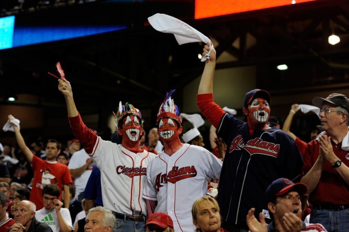 These three Indians fans painted their faces red in support of their team.