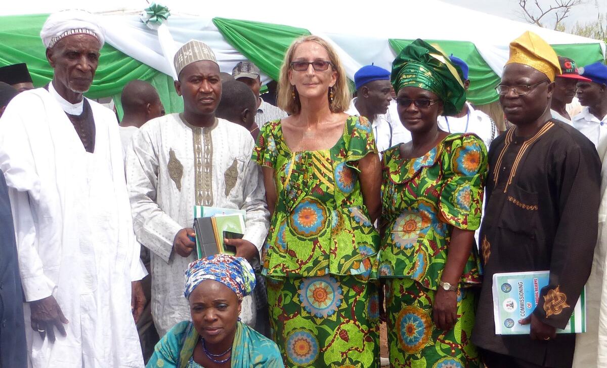 In this undated photo provided by Mike Henry, kidnapped Seattle missionary the Rev. Phyllis Sortor is shown standing at center with a delegation of area dignitaries in a town in Nigeria.