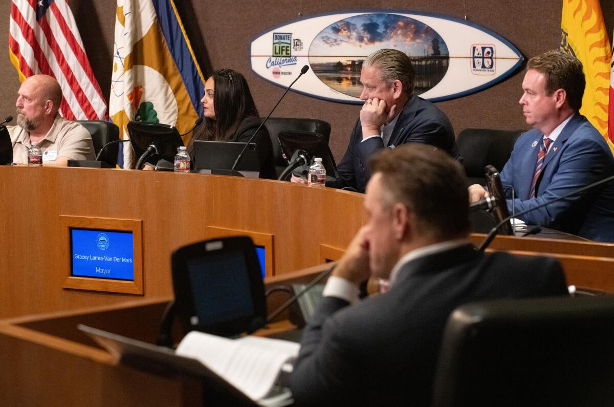 The four conservative members of the Huntington Beach City Council listen to public comments during Tuesday's meeting.