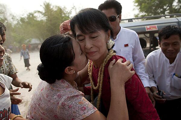 A supporter kisses Aung San Suu Kyi