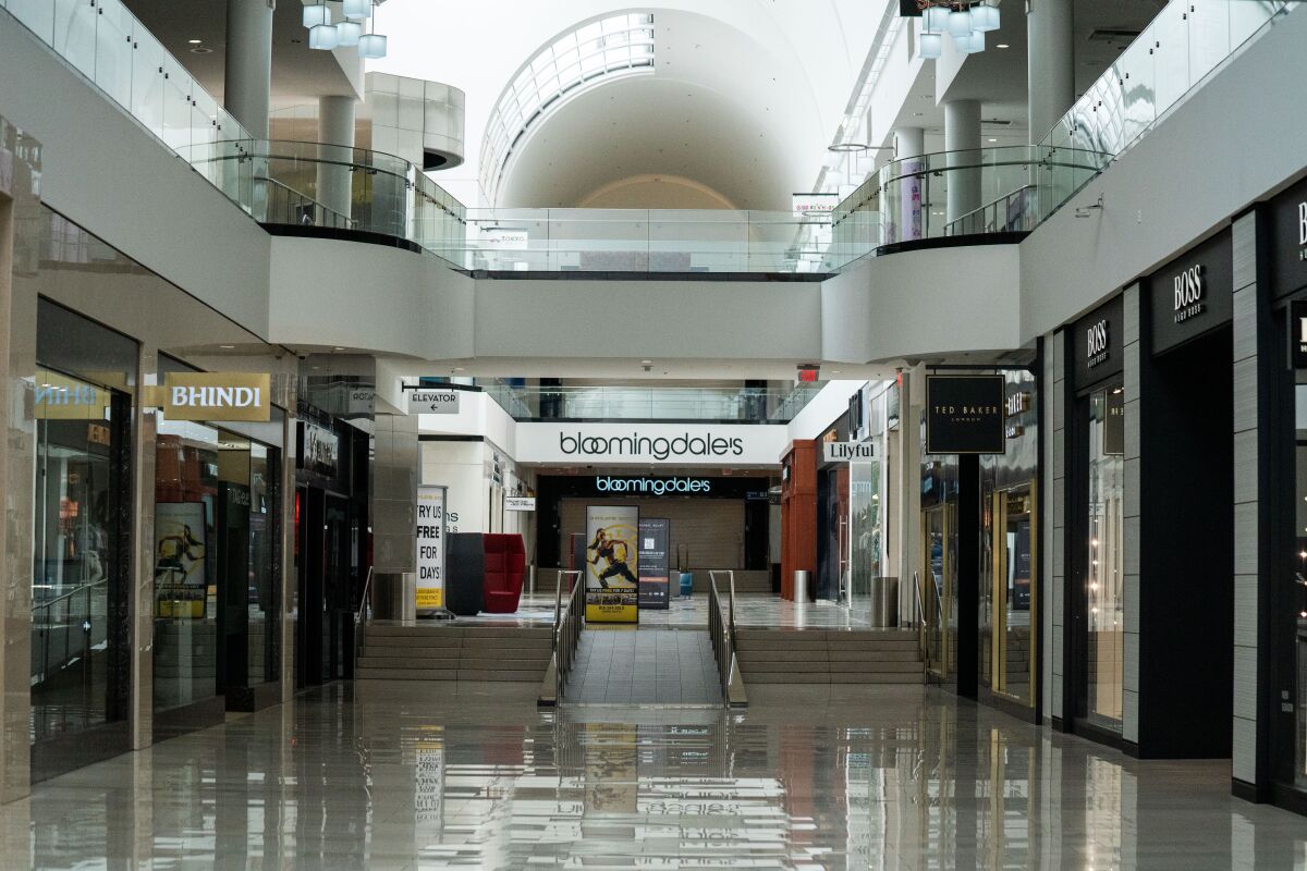 An empty corridor of the Glendale Galleria, where many shops, despite the mall's reopening, remained closed on Thursday.