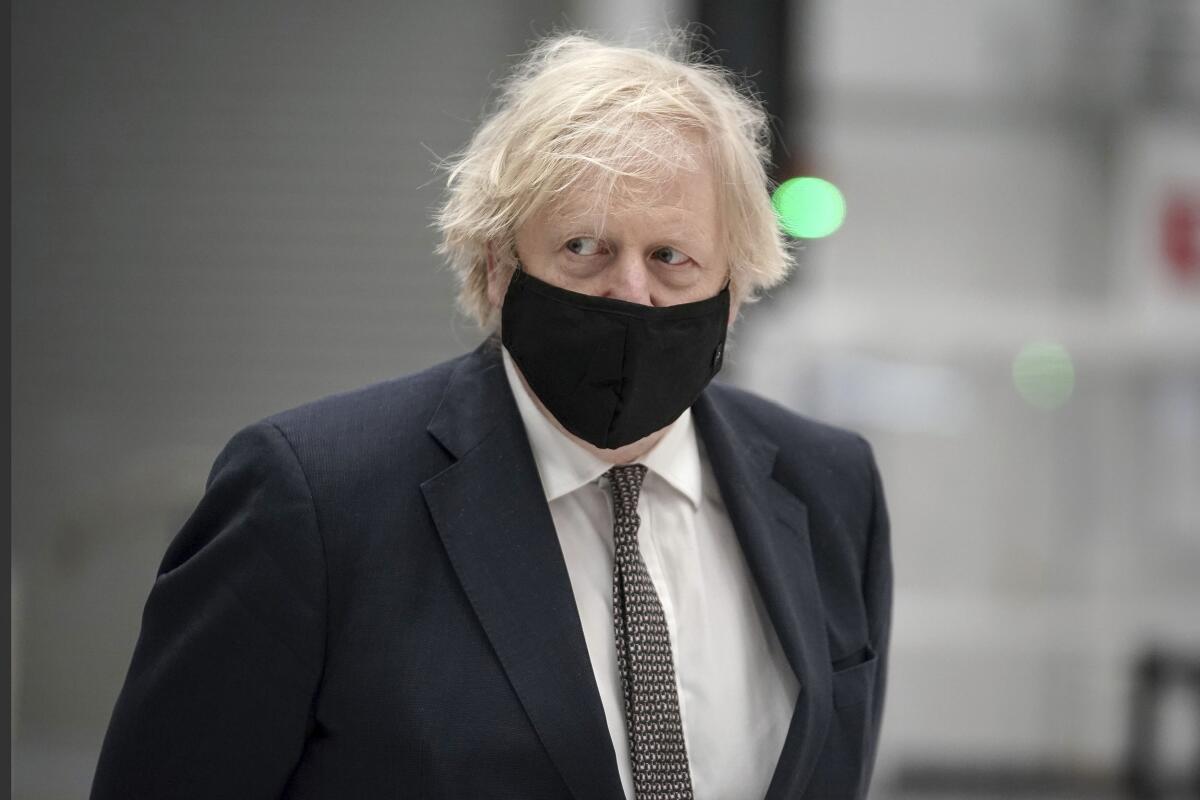 A closeup of Boris Johnson in a mask.