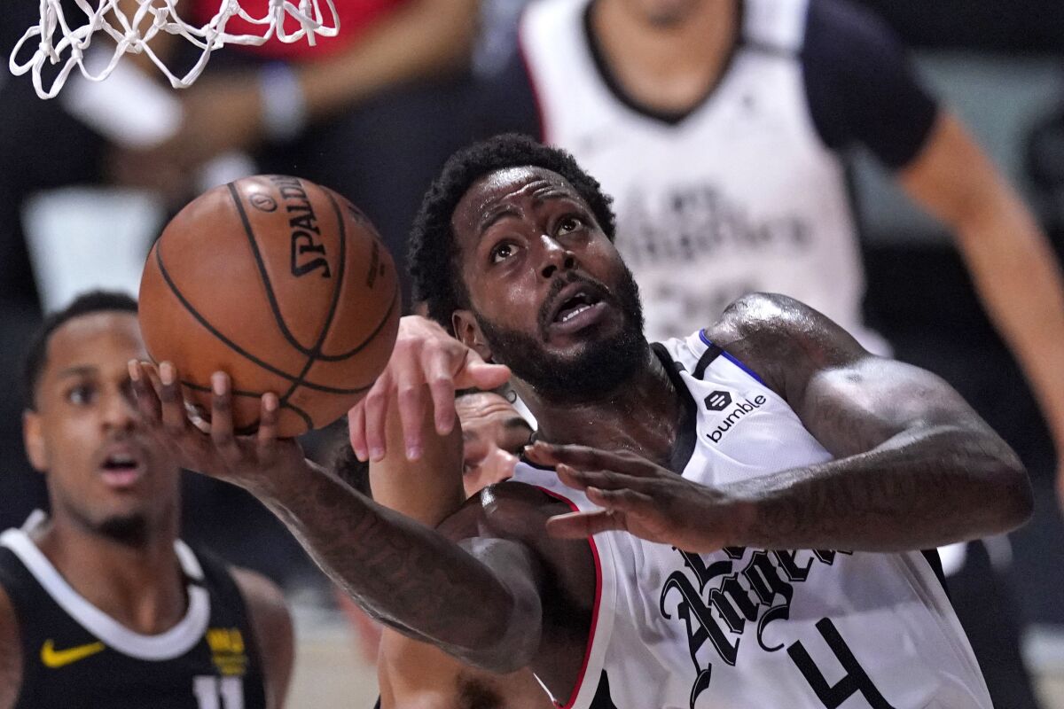 Clippers forward JaMychal Green puts up a shot in front of Denver's Michael Porter Jr. during Game 6 on Sunday.