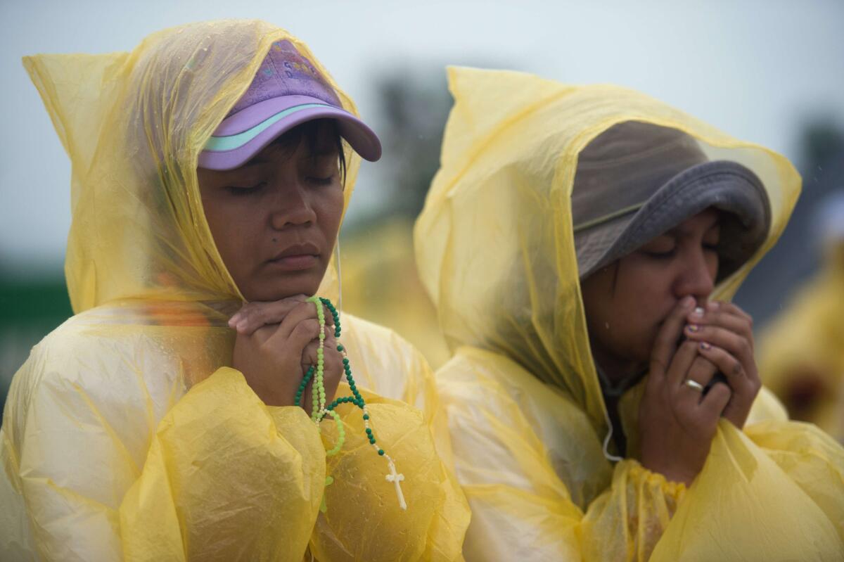 Worshipers pray at a Mass held by Pope Francis in Tacloban, Philippines.
