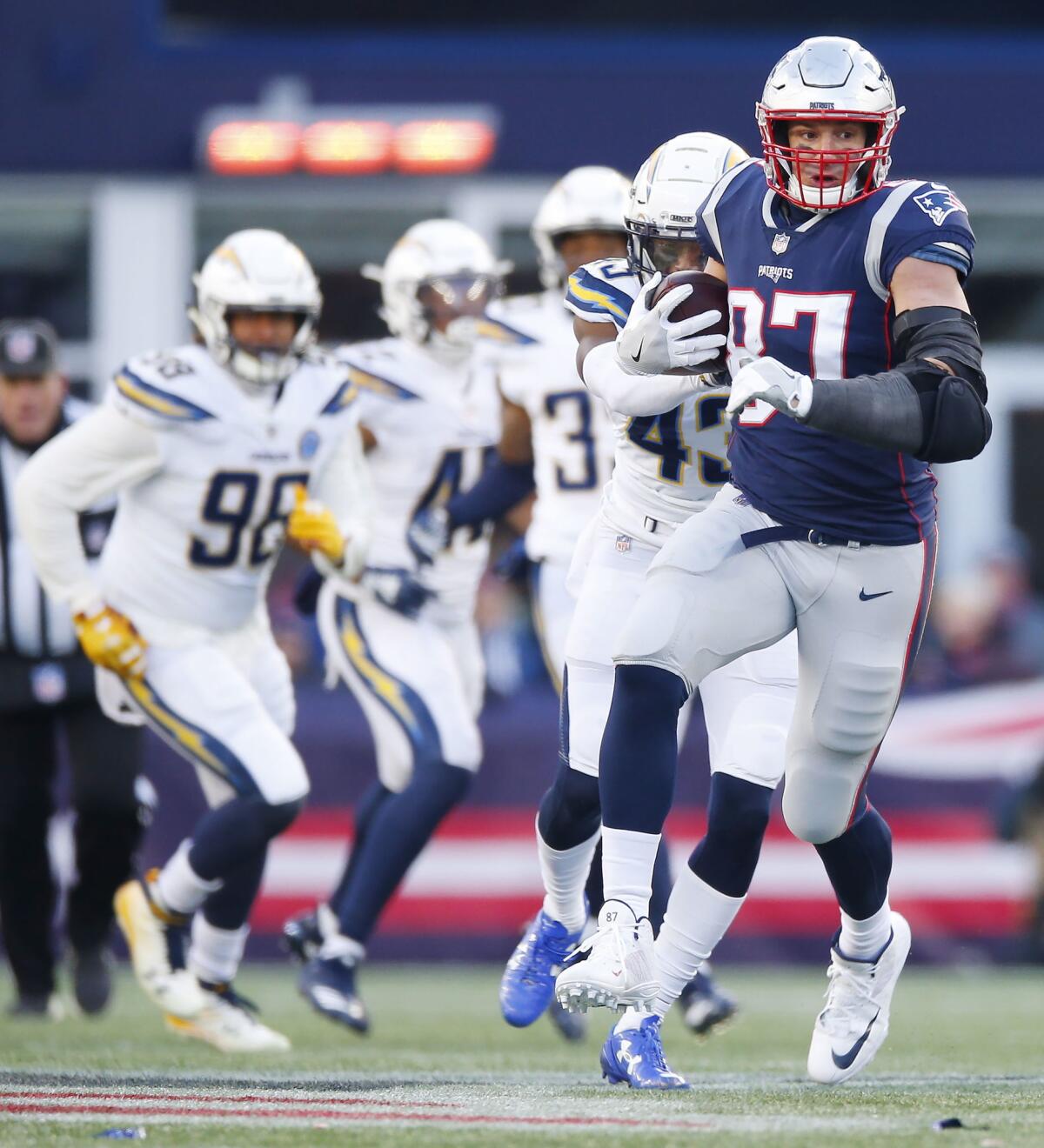 New England Patriots tight end Rob Gronkowski (R) runs after a reception against the Los Angeles Chargers in the third quarter of their AFC Divisional Playoff game at Gillette Stadium in Foxborough, Massachusetts, USA, 13 January 2019. The winner will face the Kansas City Chiefs on 20 January, 2019 in the AFC Championship game.