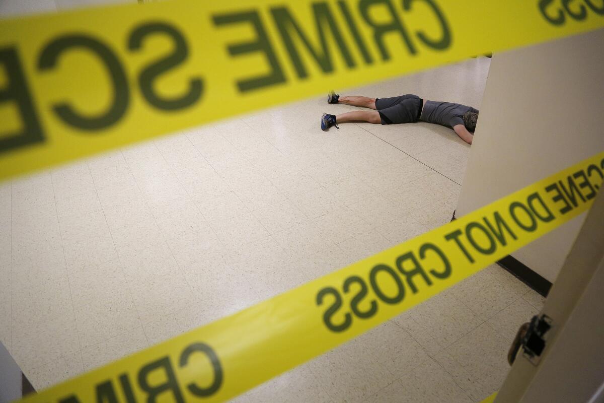 A "victim" of a school active shooter training is seen in a hallway during a drill.