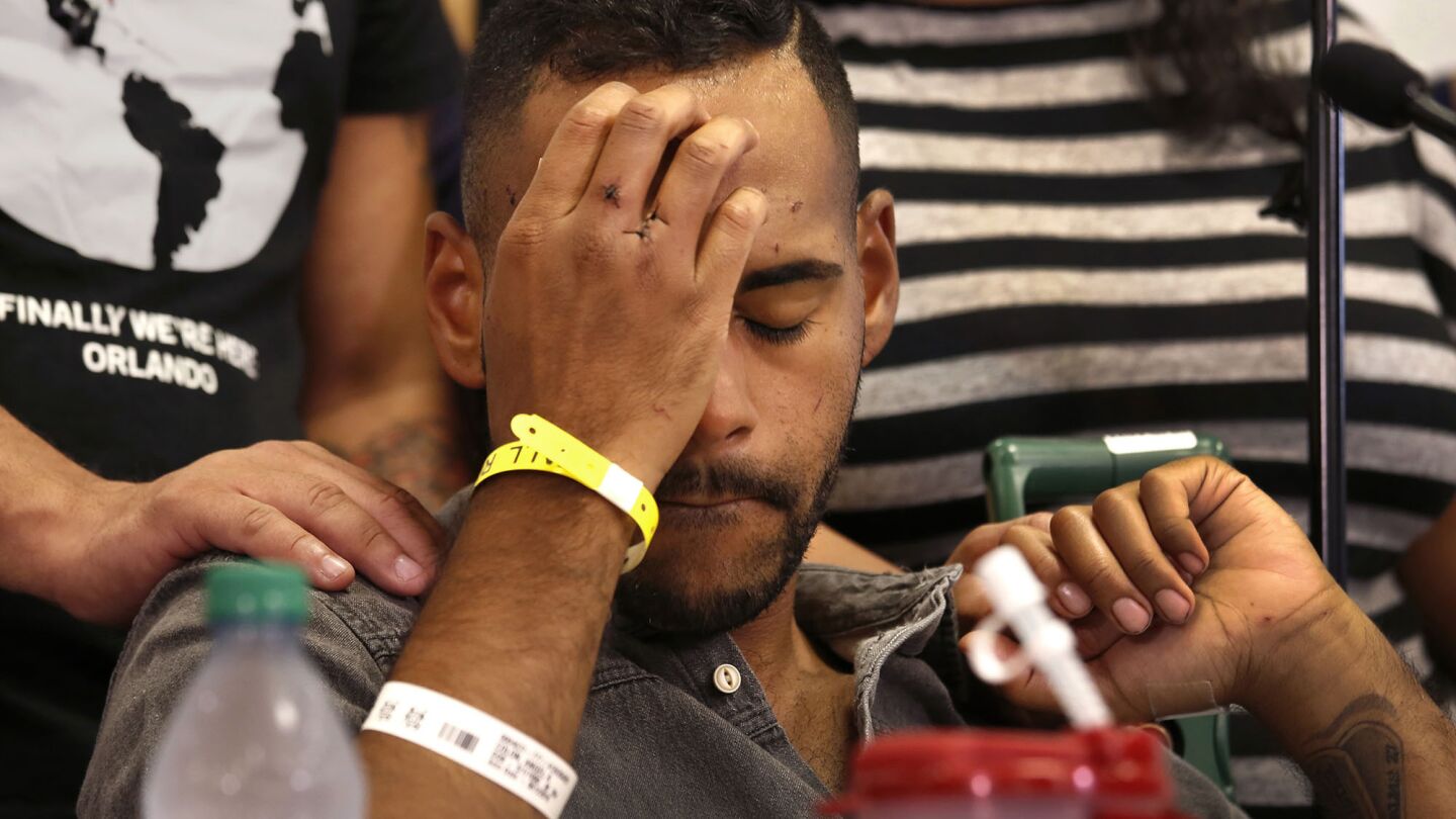 With stitches in his hand, gunshot victim Angel Colon tells his story to the media at a news conference at Orlando Regional Medical Center on Tuesday.