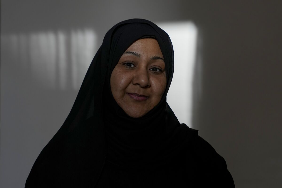 Bahraini former political prisoner Najah Yusuf poses for a photograph during an interview with The Associated Press in Manama, Bahrain, Thursday, March 17, 2022. As Formula One begins the new season in Bahrain at a track where a huge contract extension was recently signed, Yusuf still waits for compensation after allegedly being tortured and abused in a Bahrain jail over a social media post demanding justice for those imprisoned for protesting the annual race. (AP Photo)