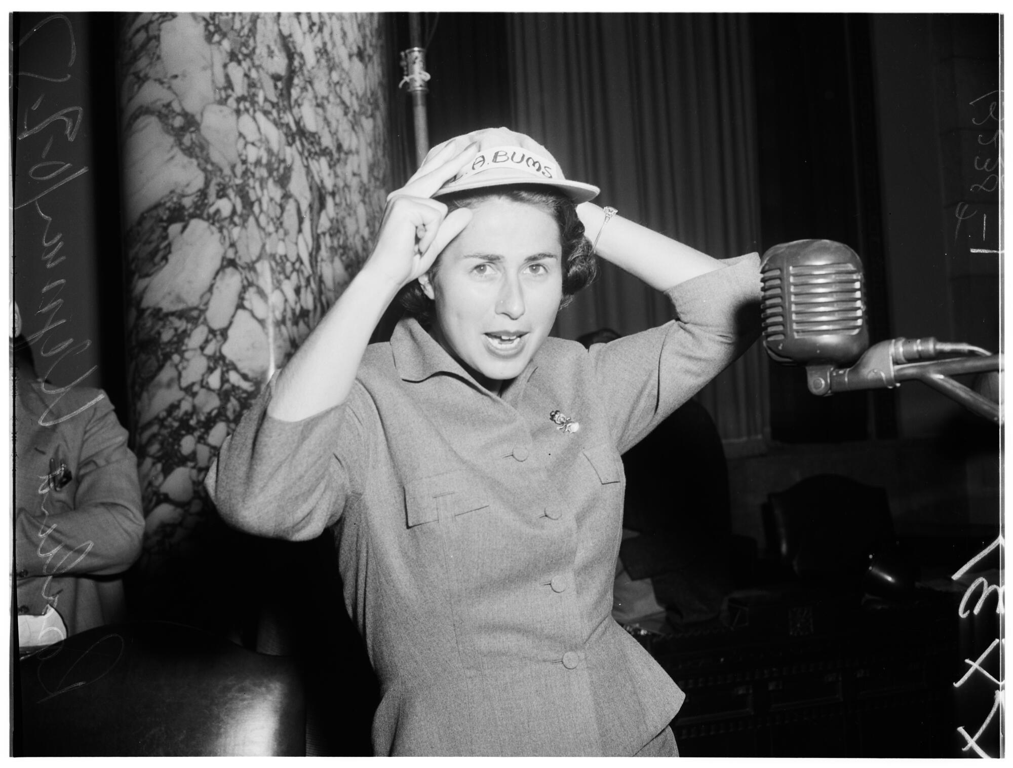 Rosalind Wyman wearing a baseball hat with "Bums" on it.