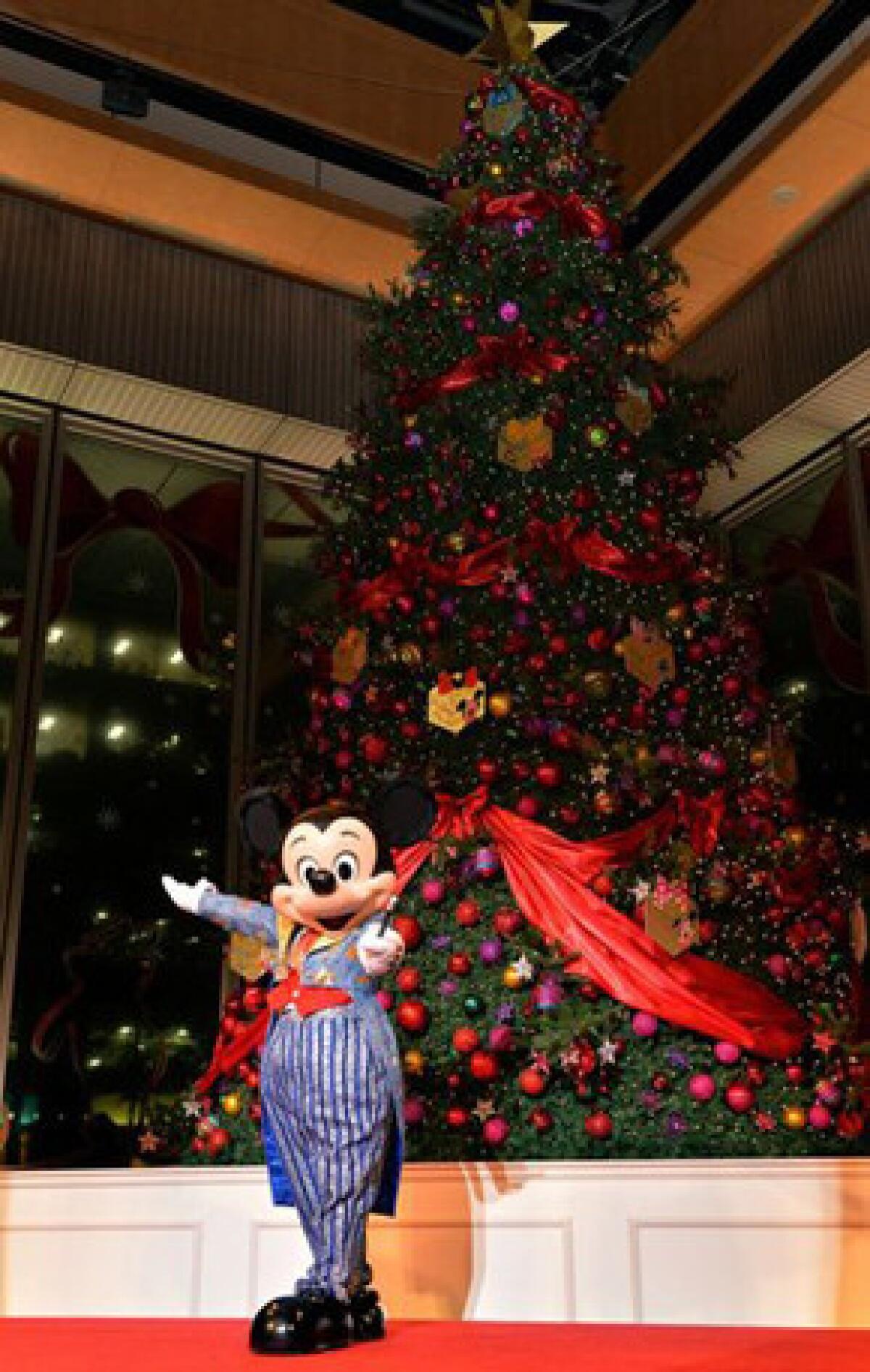 Mickey Mouse, shown at a Christmas tree lighting ceremony in Tokyo last week, is expected at Fashion Island's lighting ceremony.