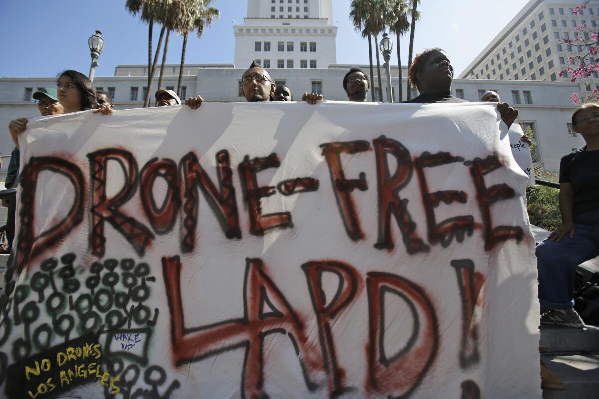 Mario Bautista, middle, along with other members of Stop LAPD Spying Coalition, holds a press conference outside Los Angeles City Hall in downtown Los Angeles.