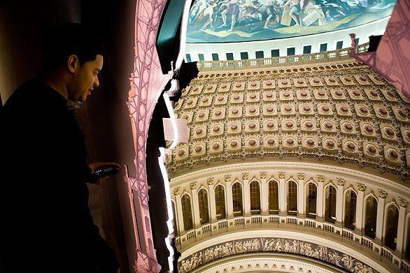 A guest looks at a model of the U.S. Capitol dome after the opening ceremony Tuesday for the new Capitol Visitor Center in Washington.