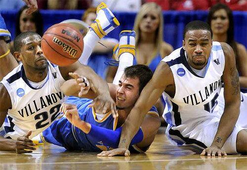 UCLA forward Nikola Dragovic comes up with a loose ball and makes a pass between Villanova's Dwayne Anderson, left, and Reggie Redding during the first half Saturday.
