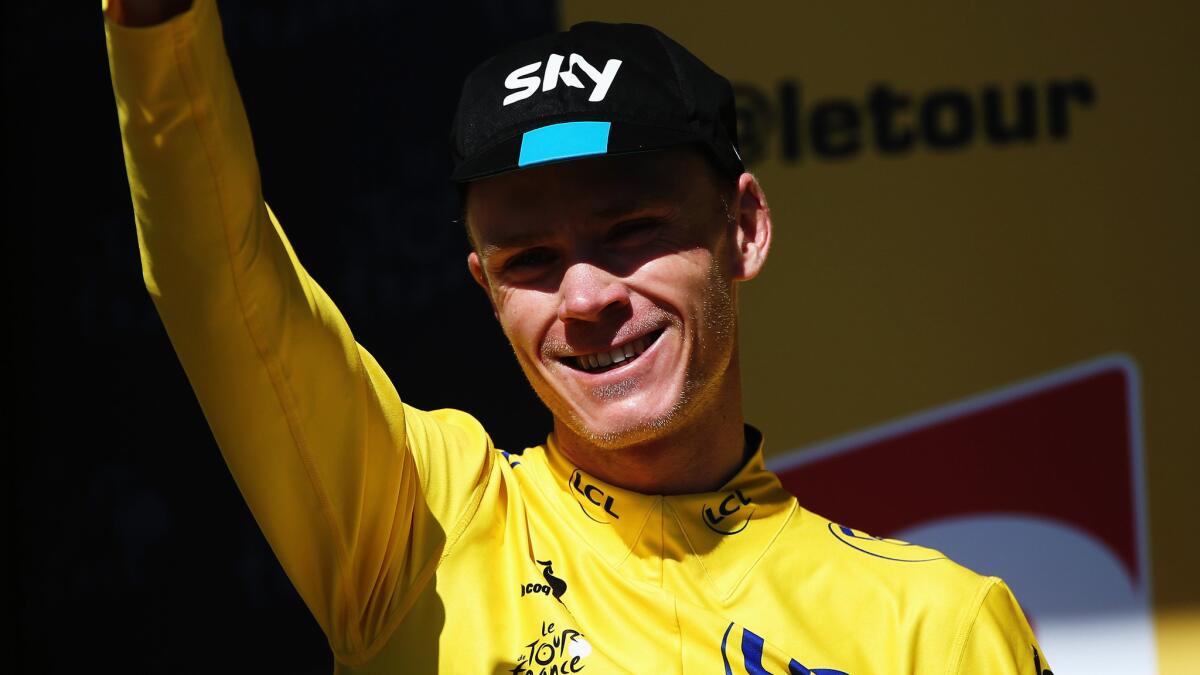 Overall leader Chris Froome celebrates on the podium after the 20th stage of the Tour de France on Saturday.