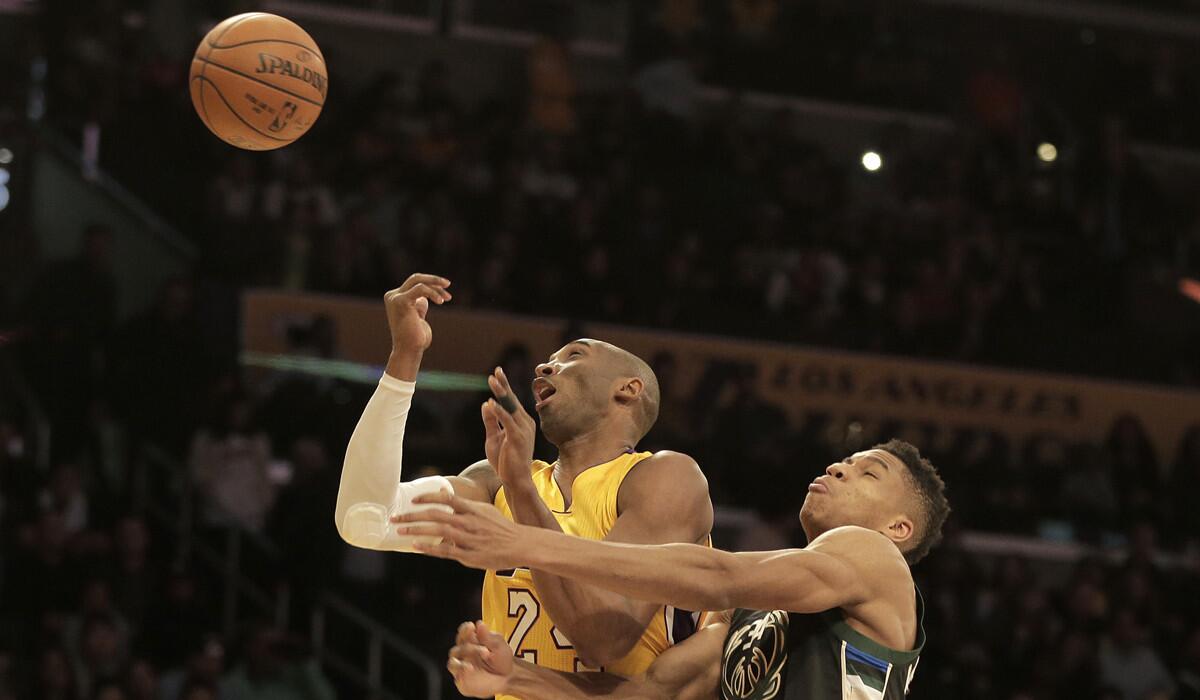 The Lakers' Kobe Bryant gets fouled by Milwaukee Bucks forward Giannis Antetokounmpo during a Dec. 15 game at Staples Center.