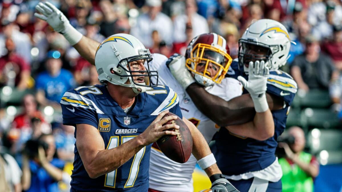 Chargers quarterback Philip Rivers scrambles away from pressure during a first-quarter drive against the Redskins at Stubhub Center.