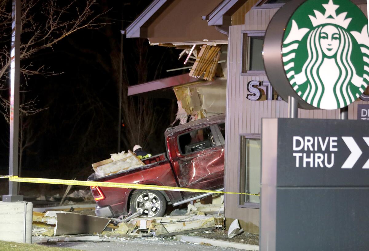 Personnel work at the scene in McHenry, Ill. where a vehicle drove into the Starbucks Thursday, Jan. 16, 2020. (Patrick Kunzer/Daily Herald via AP)