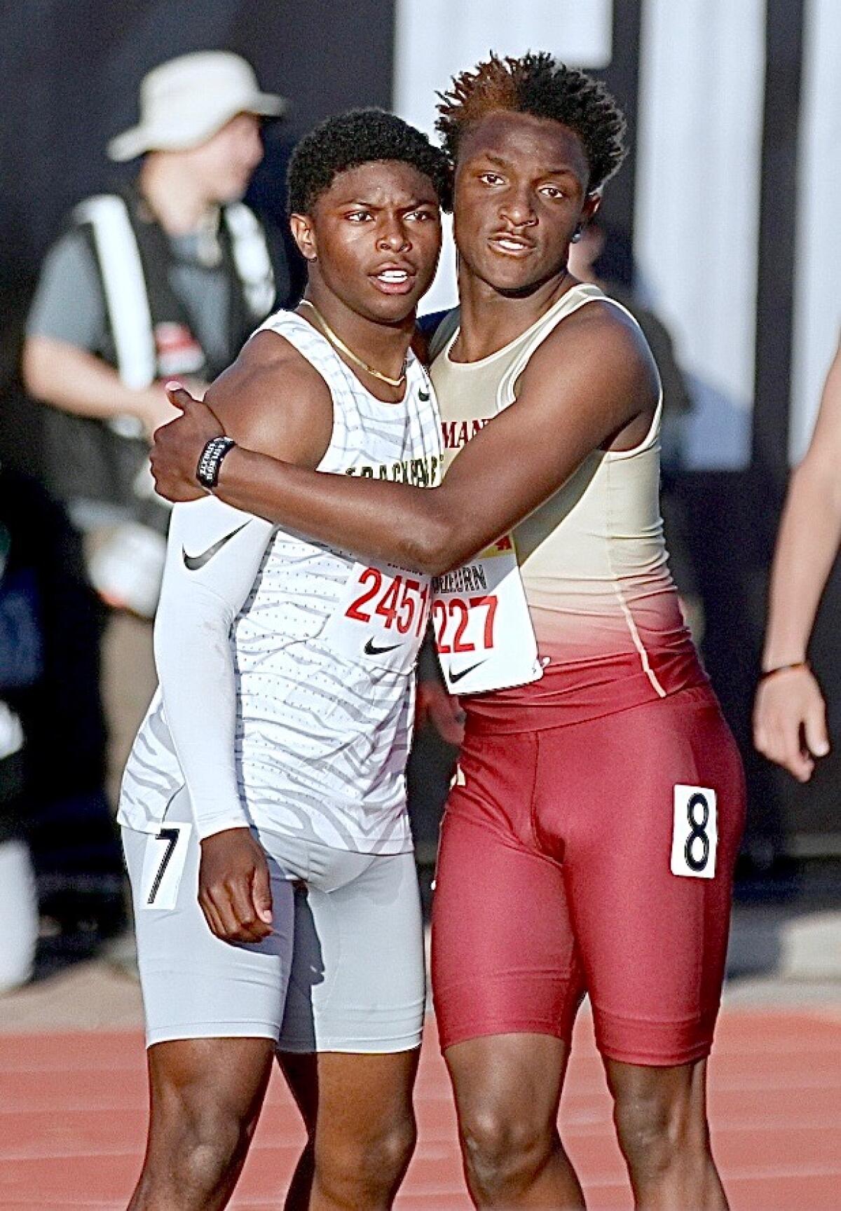 Class of 2027 sprinters Benjamin Harris of Long Beach Poly (left) and Demare Dezeurn of Alemany  at Arcadia Invitational.