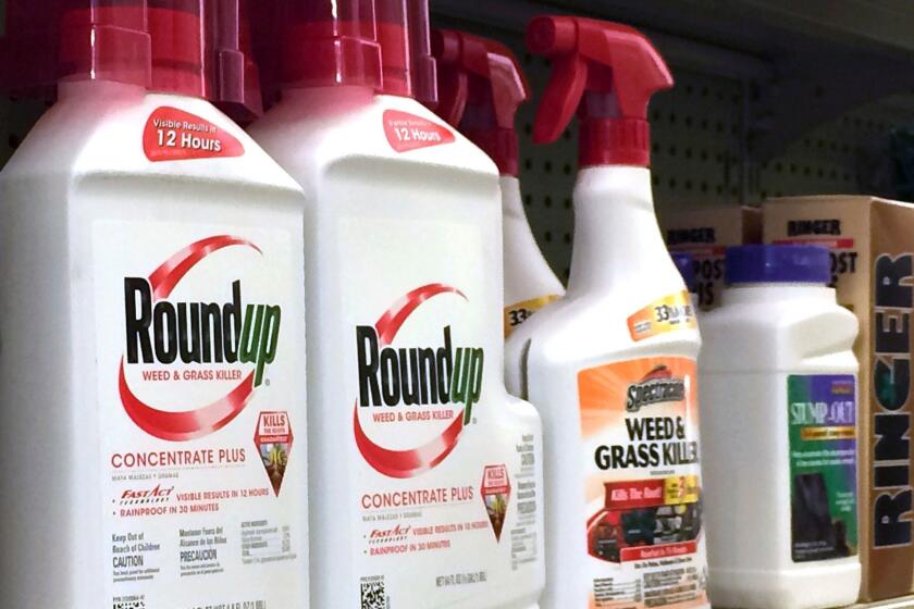 Containers of Monsanto's weed killer Roundup on a hardware store shelf in Los Angeles.