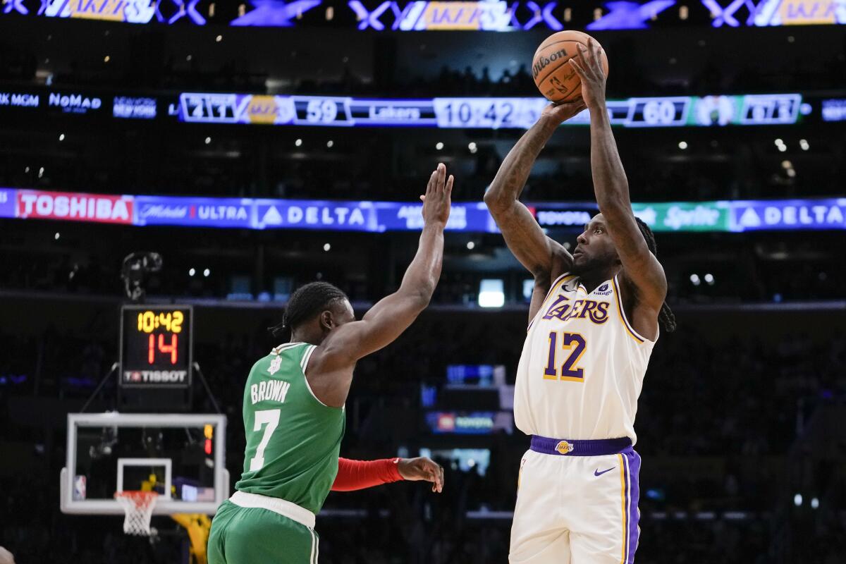 Lakers forward Taurean Prince shoots over Boston Celtics guard Jaylen Brown during the second half Monday.