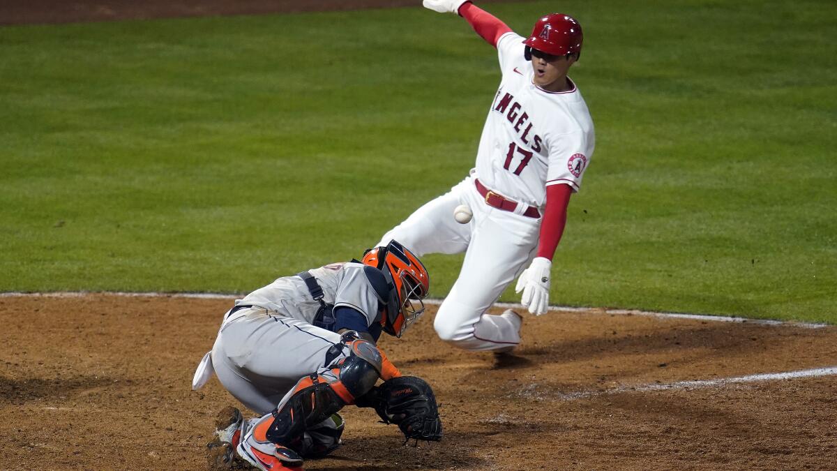 Trout homers, Angels rally in 8th to hand Astros 1st loss