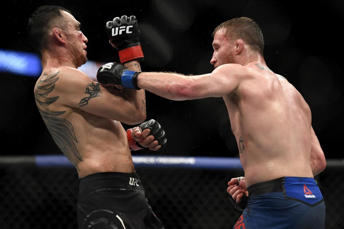 Henry Cejudo, left, reacts after defeating Dominick Cruz in Saturday night's co-main event for the UFC bantamweight title.