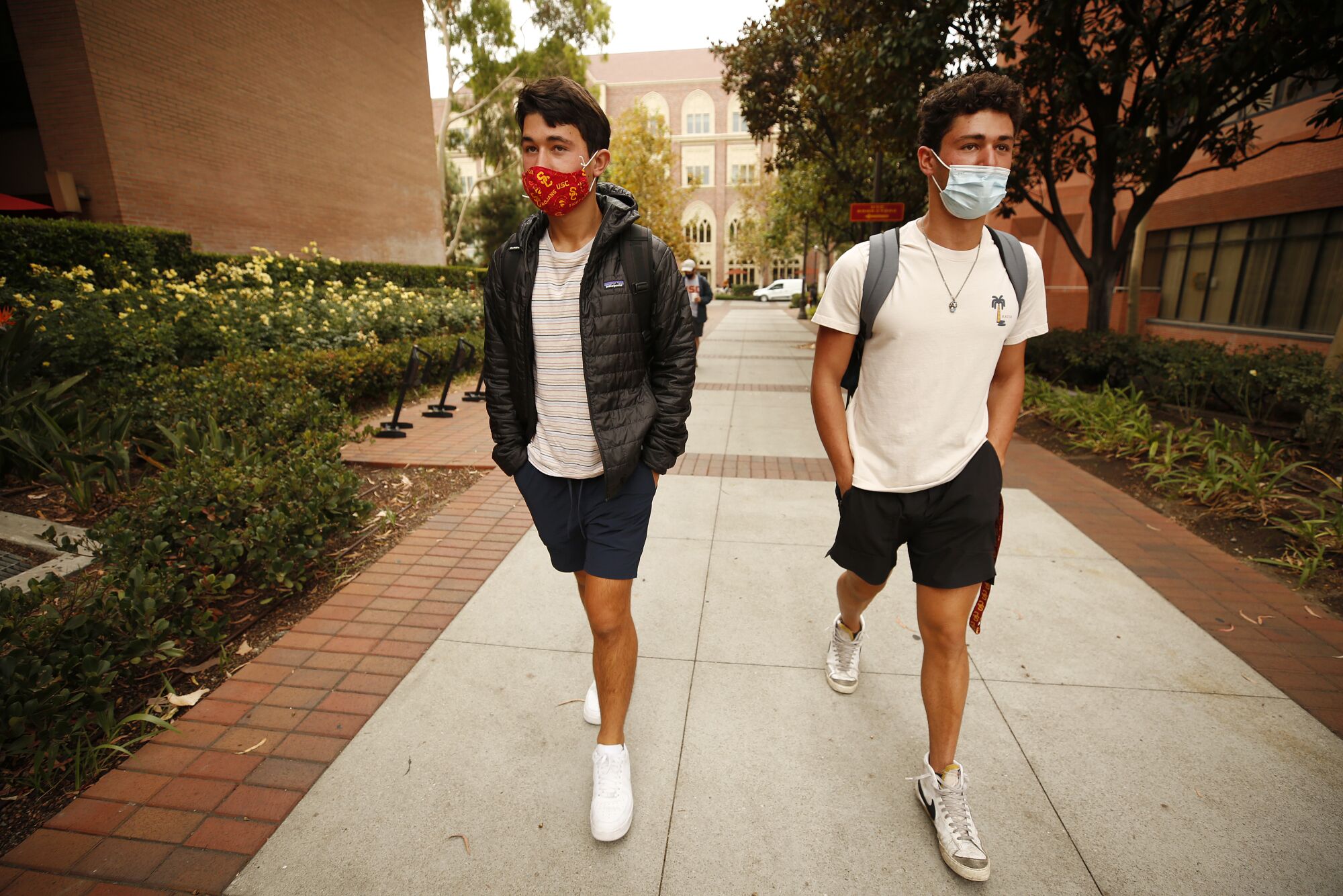 Brothers Ryan, right, and Evan Abdollahi, walk to their classes on the USC campus for the first day of in-person classes.