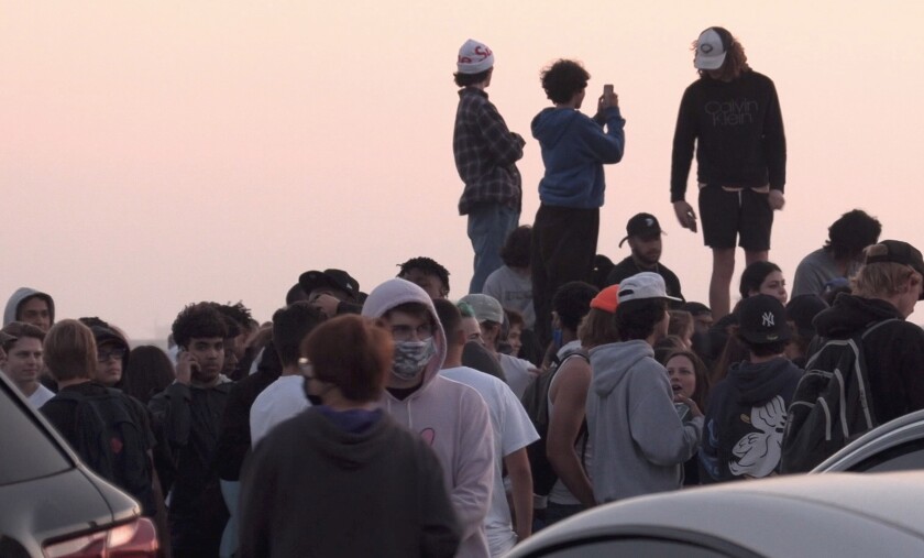 Roughly 2,500 teens and young adults converged in Huntington Beach for "Adrian's kickback." 