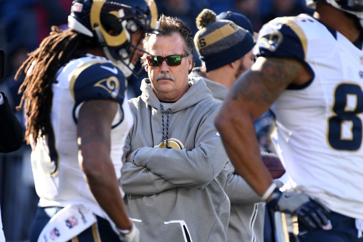Rams Coach Jeff Fisher watches his players warm up before a game against the Patriots at Gillette Stadium on Sunday.