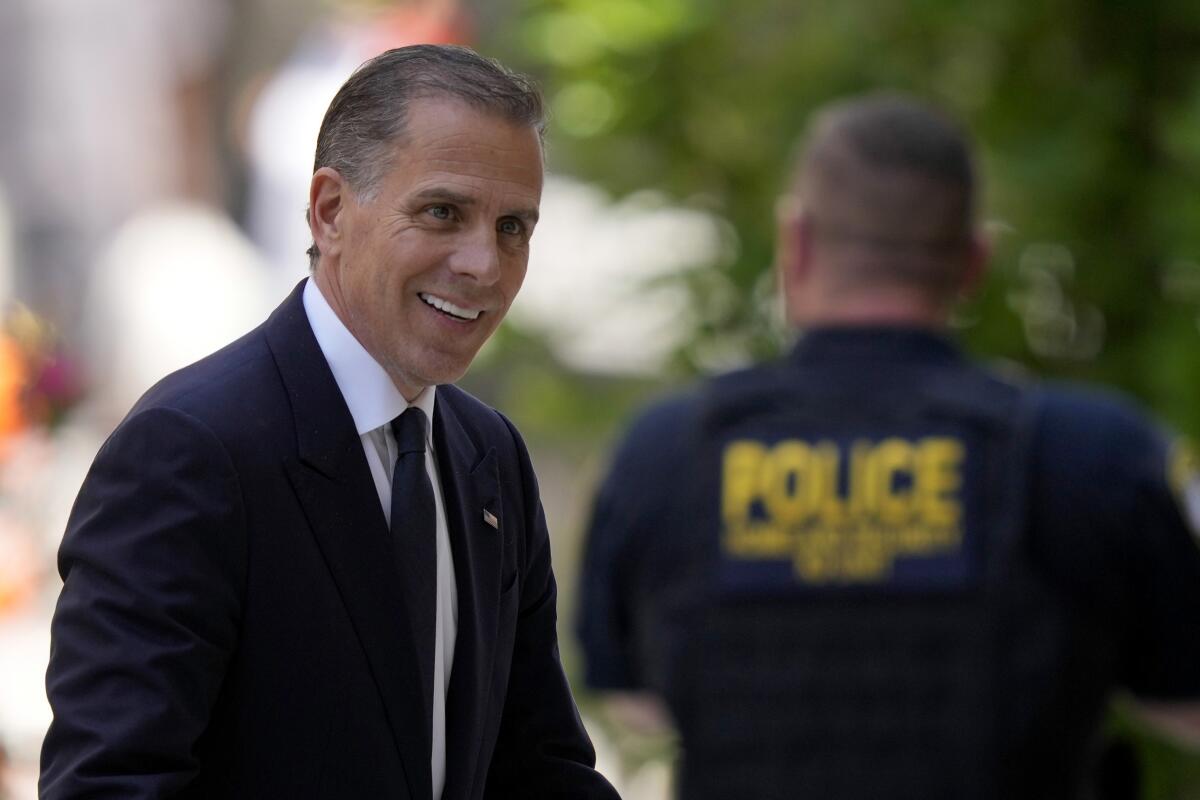 Hunter Biden smiles as he arrives for a court appearance.