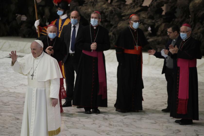 Pope Francis waves to faithful at the end of the weekly general audience in the Paul VI hall at the Vatican, Wednesday, Oct. 21, 2020. (AP Photo/Gregorio Borgia)